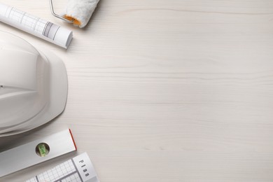 Photo of Flat lay composition with building level and other construction tools on white wooden table, space for text