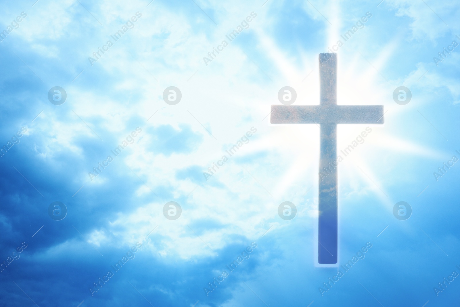 Image of Cross lit by sunlight in sky, double exposure. Religion of Christianity