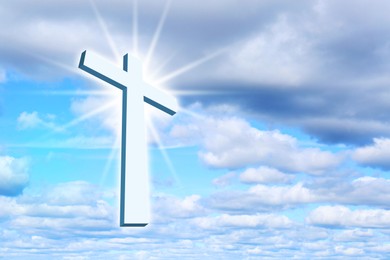 Cross lit by sunlight in sky. Religion of Christianity