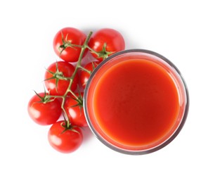 Photo of Tasty tomato juice in glass and fresh vegetables isolated on white, top view