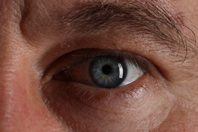 Macro photo of man with beautiful blue eyes