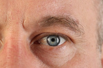 Macro photo of man with beautiful blue eyes