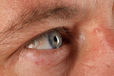 Photo of Macro photo of man with beautiful blue eyes