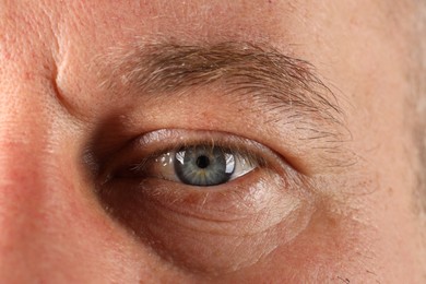 Macro photo of man with beautiful blue eyes