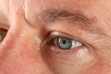 Photo of Macro photo of man with beautiful blue eyes