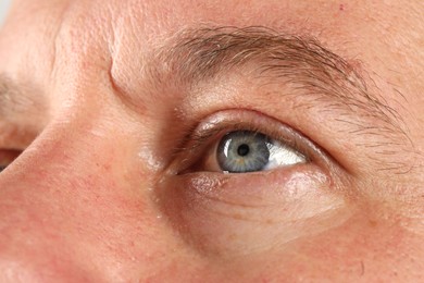 Macro photo of man with beautiful blue eyes