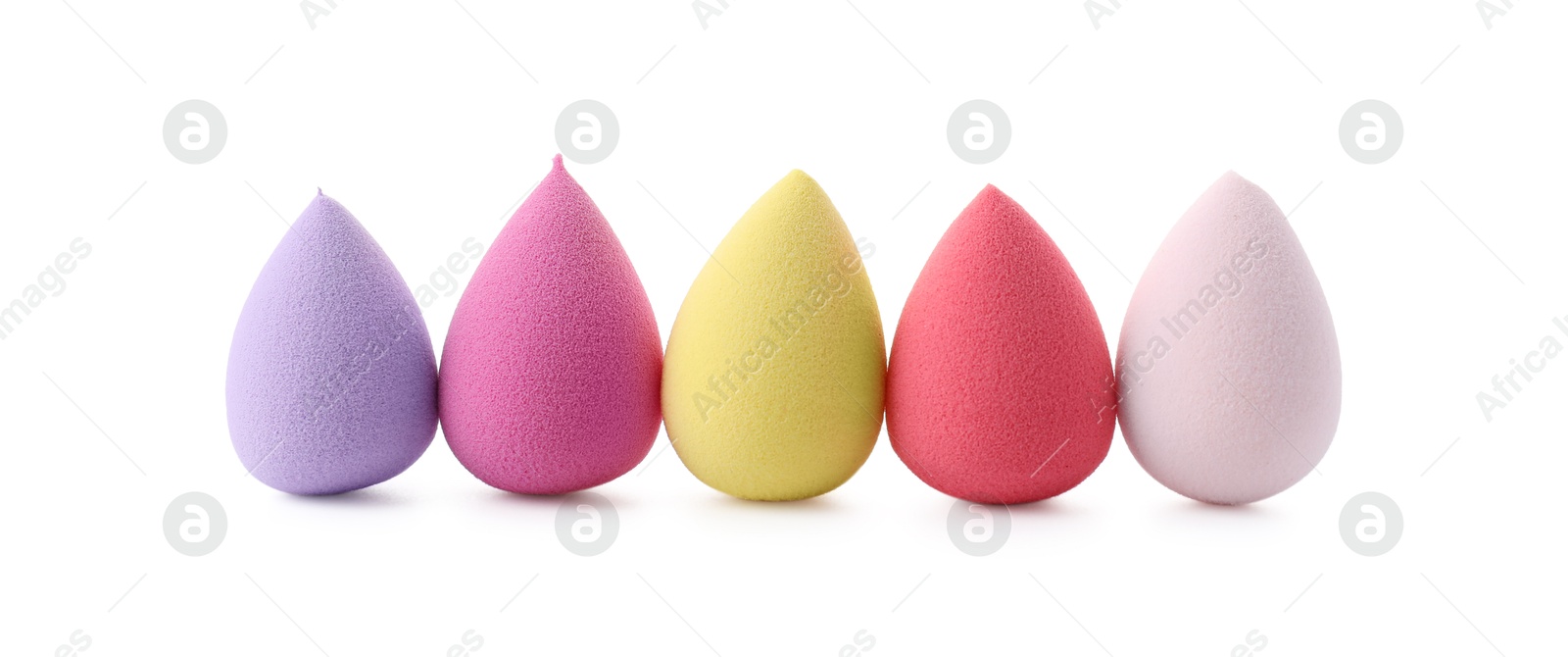 Photo of Many colorful makeup sponges isolated on white