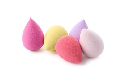 Many colorful makeup sponges isolated on white