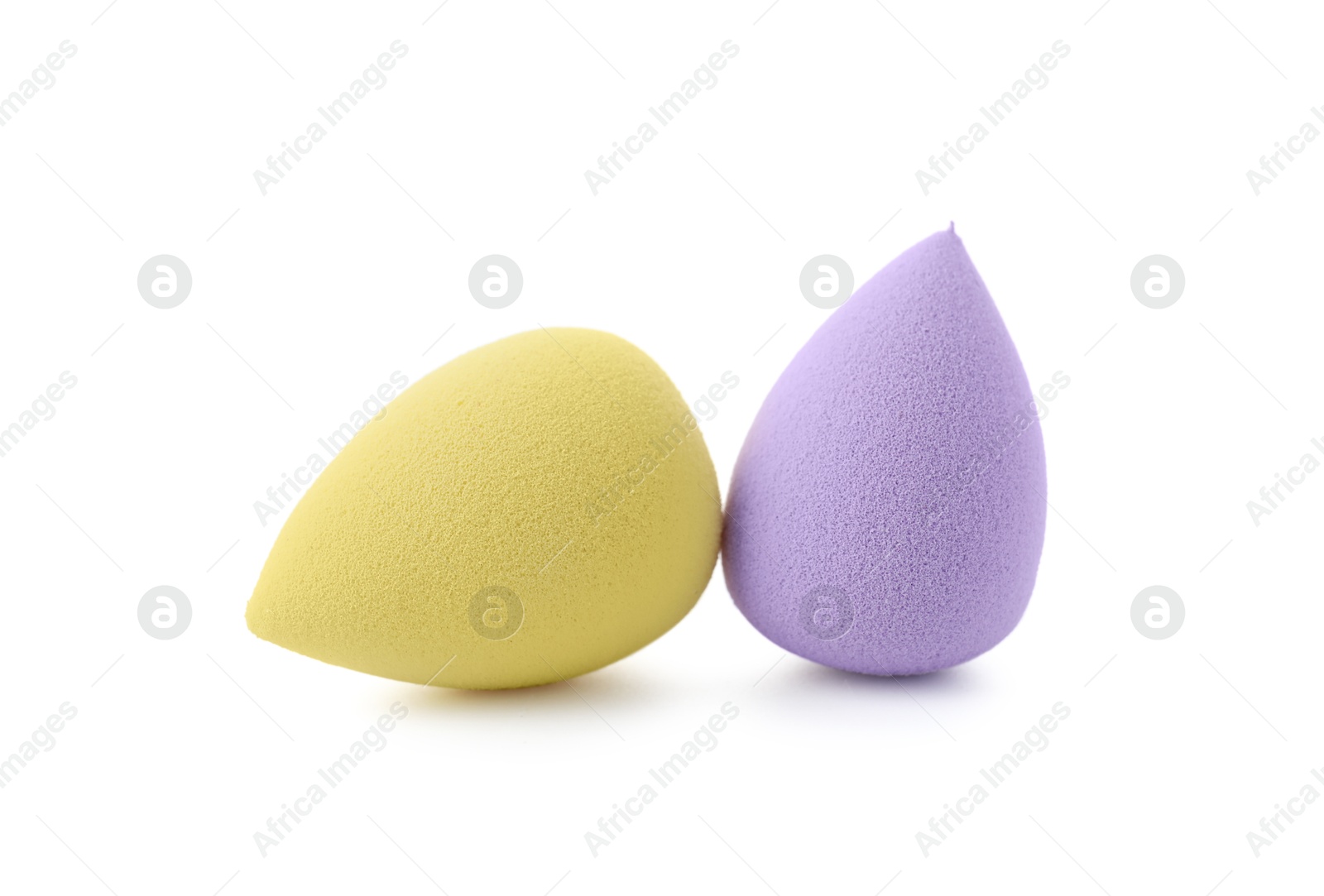 Photo of Yellow and violet makeup sponges isolated on white