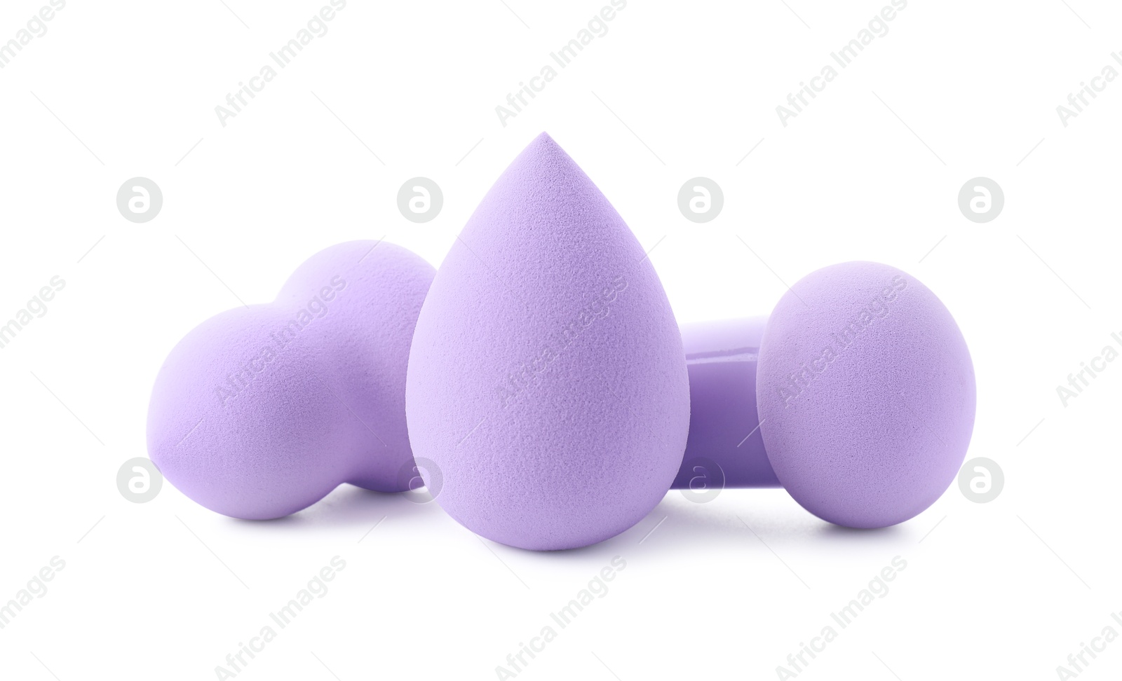 Photo of Three violet makeup sponges isolated on white