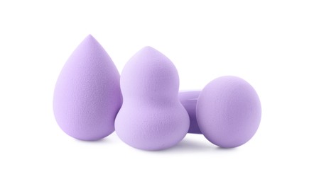 Photo of Three violet makeup sponges isolated on white