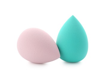 Photo of Beige and turquoise makeup sponges isolated on white