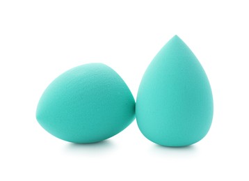 Photo of Two turquoise makeup sponges isolated on white