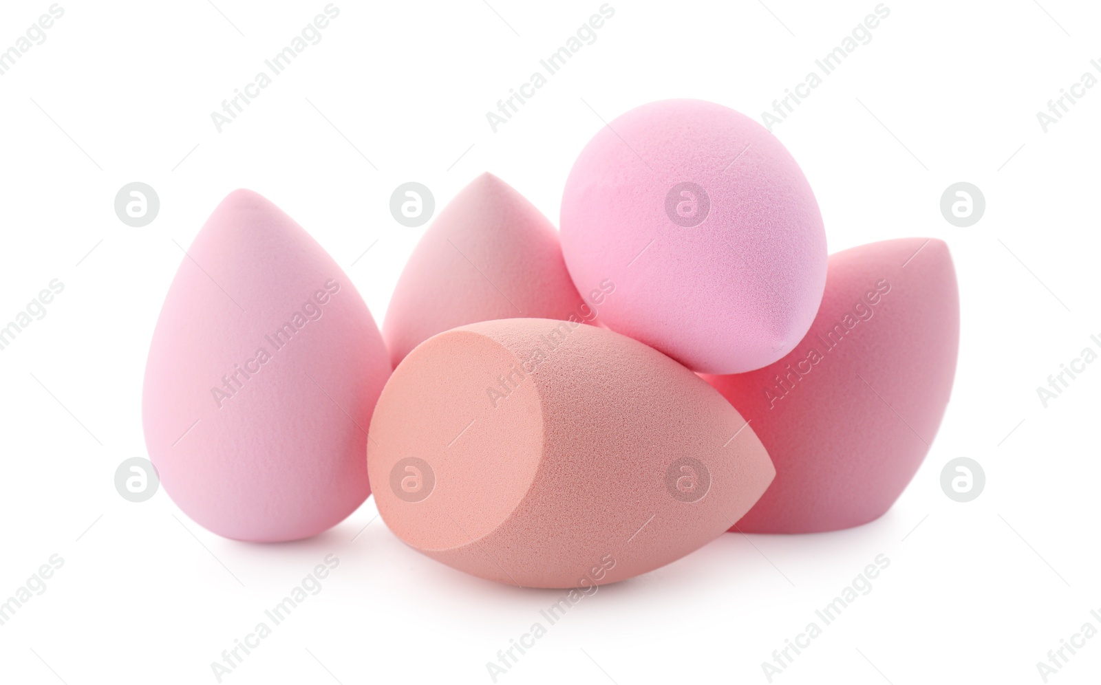 Photo of Pink and beige makeup sponges isolated on white