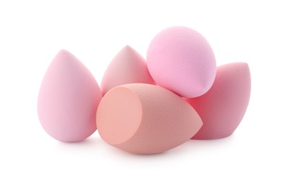 Photo of Pink and beige makeup sponges isolated on white