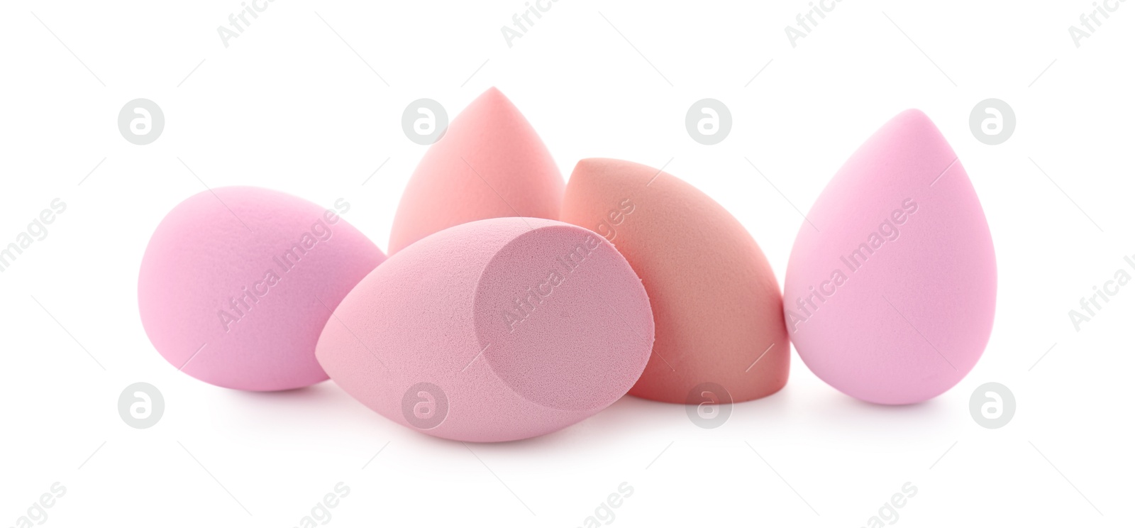 Photo of Pink and beige makeup sponges isolated on white