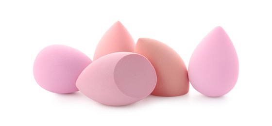 Photo of Pink and beige makeup sponges isolated on white