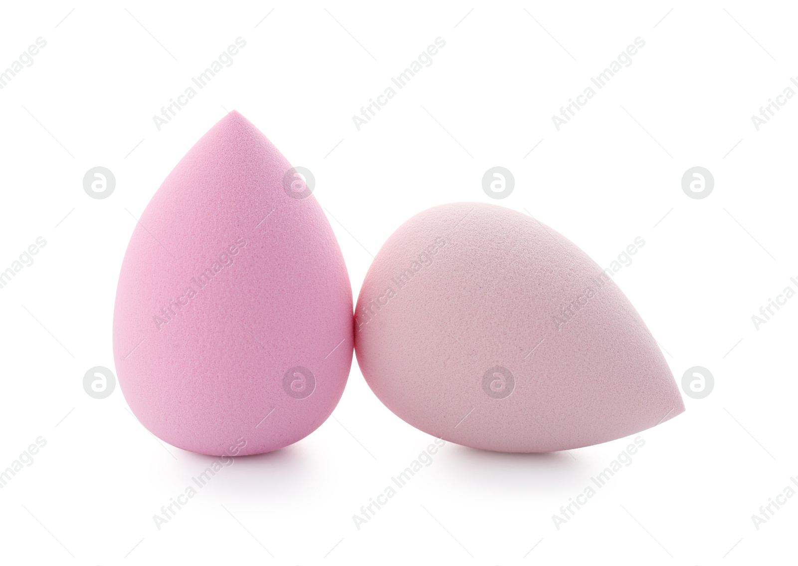 Photo of Pink and beige makeup sponges isolated on white