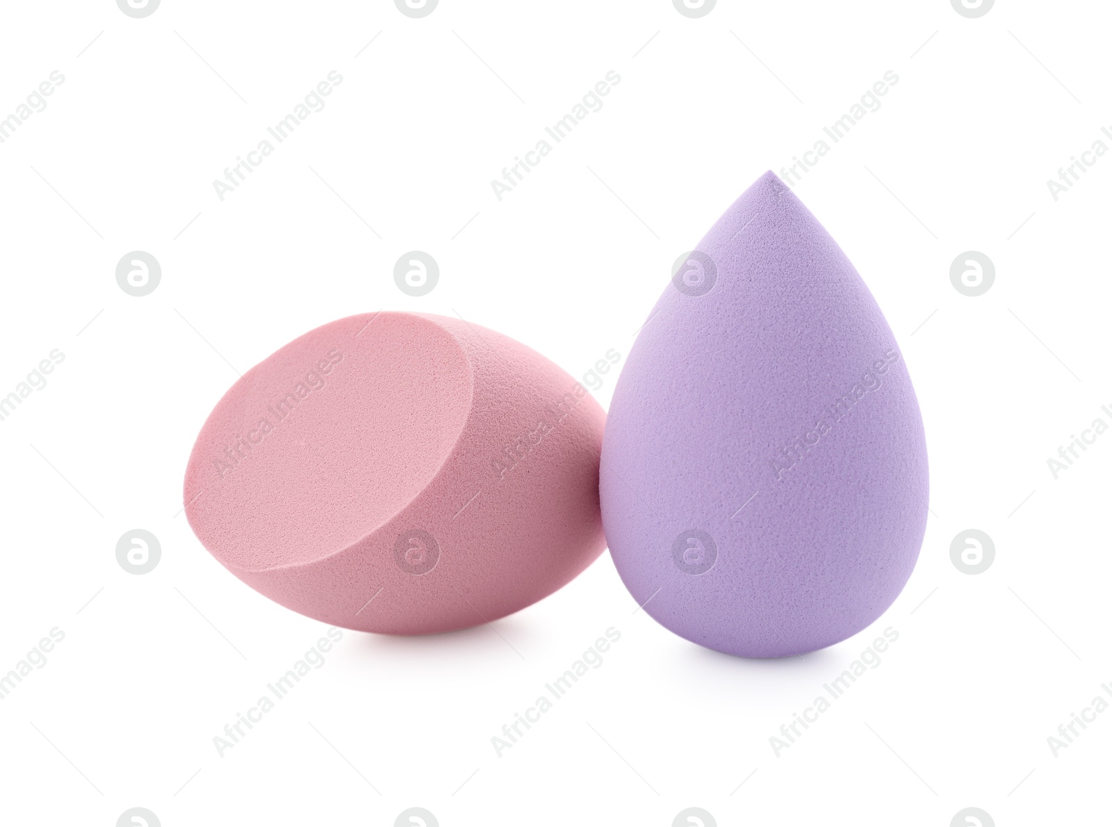 Photo of Pink and violet makeup sponges isolated on white