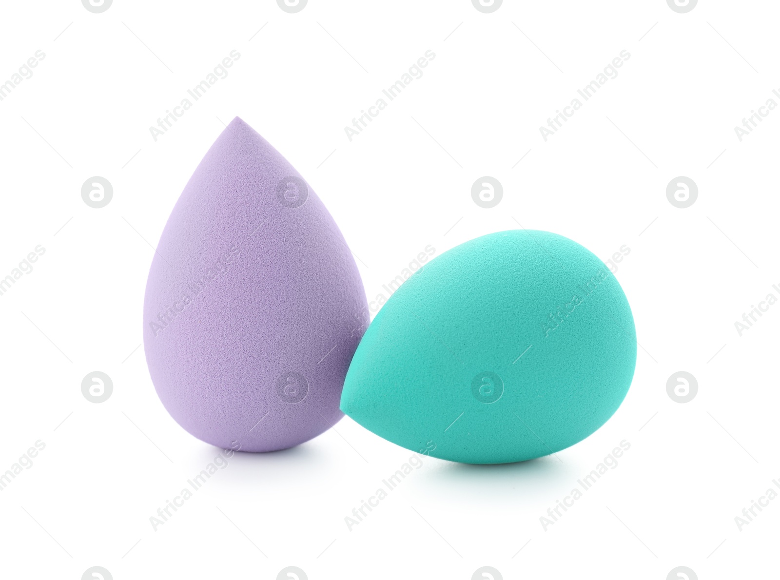 Photo of Violet and turquoise makeup sponges isolated on white