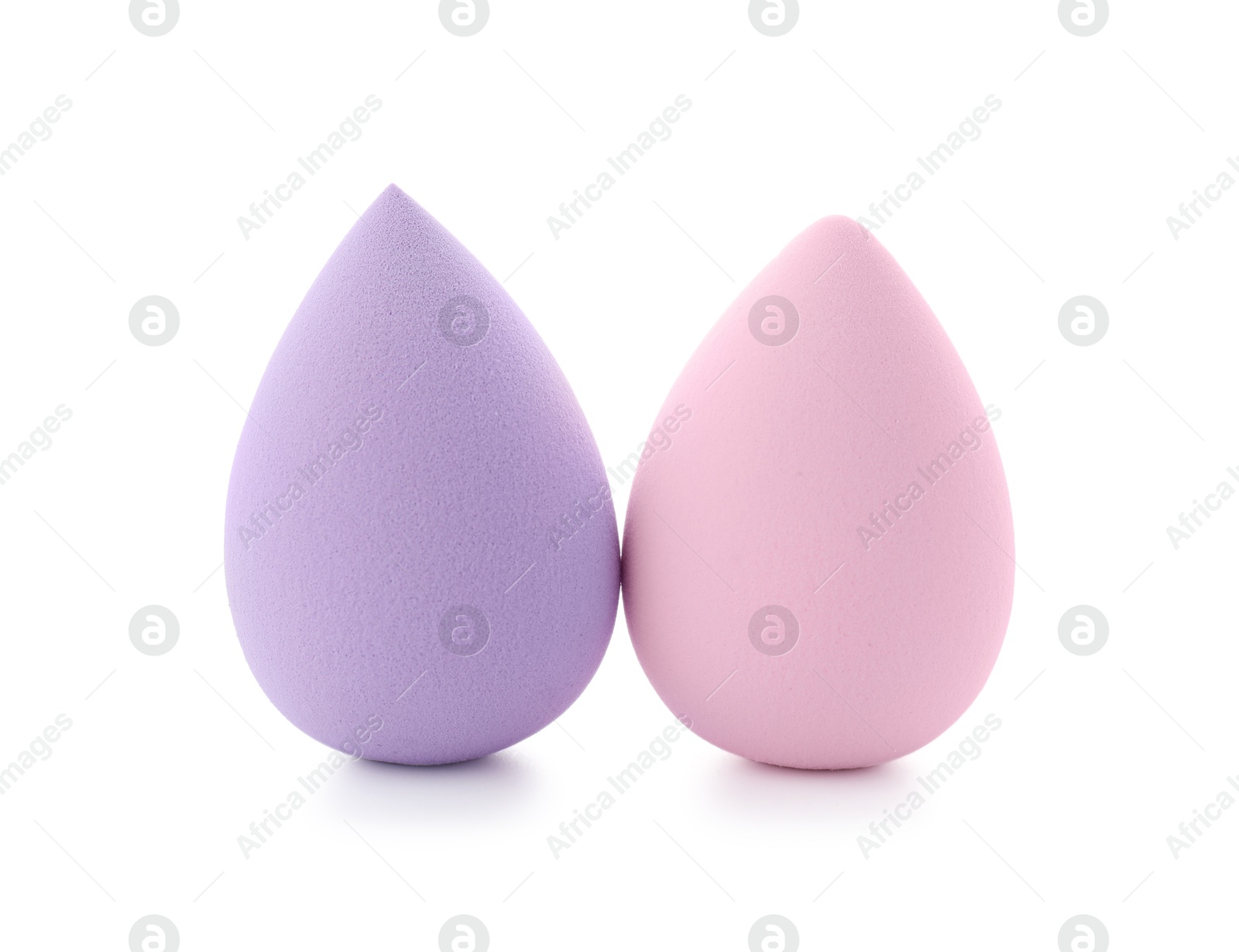 Photo of Violet and pink makeup sponges isolated on white