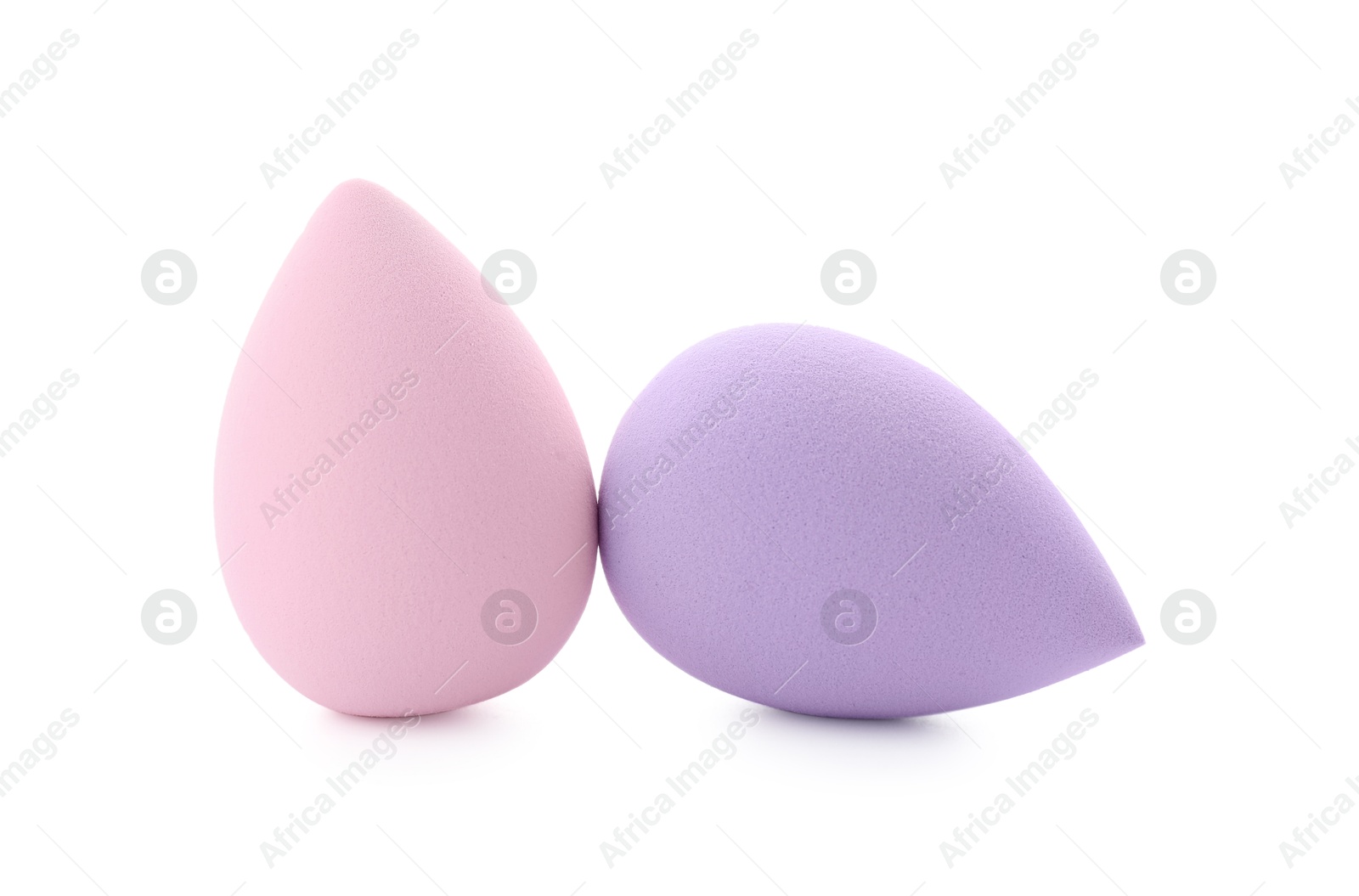 Photo of Pink and violet makeup sponges isolated on white