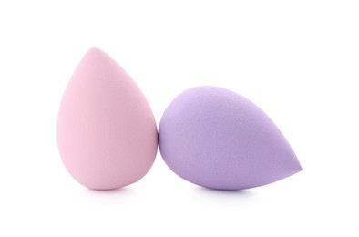 Photo of Pink and violet makeup sponges isolated on white