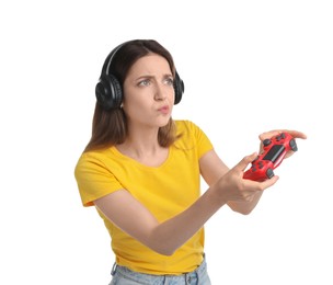 Woman in headphones playing video game with controller on white background