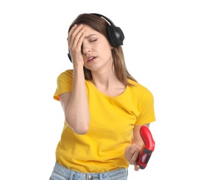 Upset woman with game controller on white background