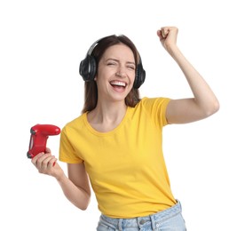 Happy woman in headphones with game controller on white background
