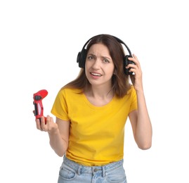 Photo of Confused woman in headphones with game controller on white background