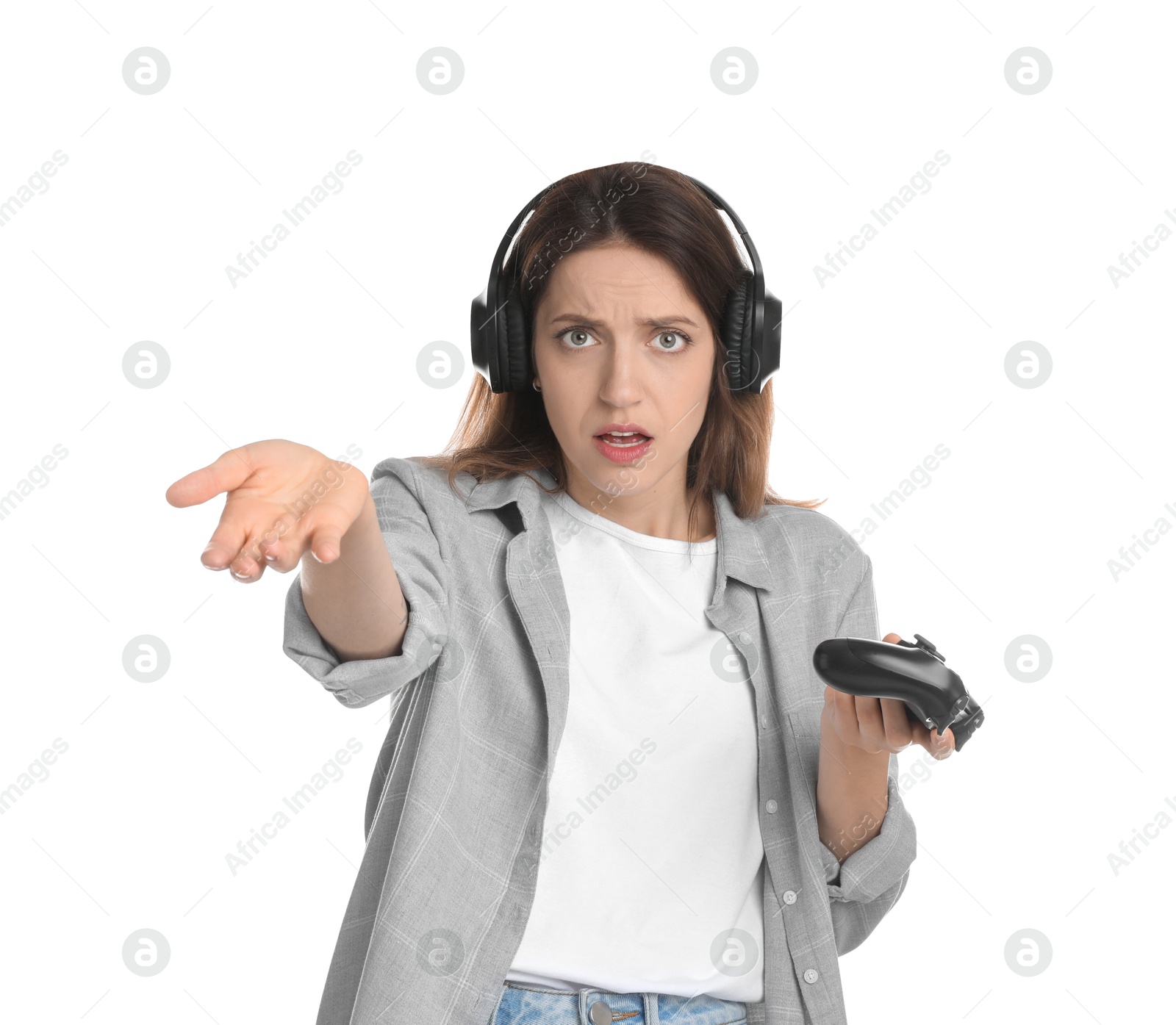 Photo of Confused woman in headphones with game controller on white background