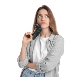 Sad woman with game controller on white background