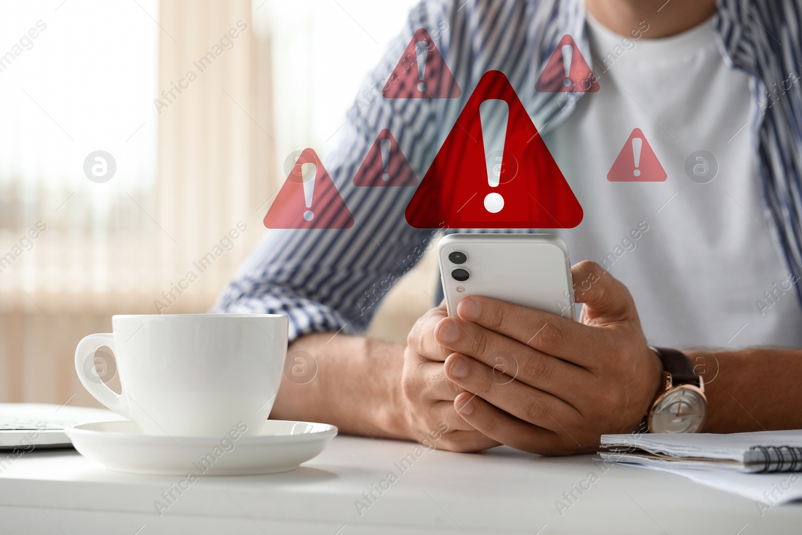 Image of Woman using smartphone at table indoors, closeup. Warning signs for spam message above device