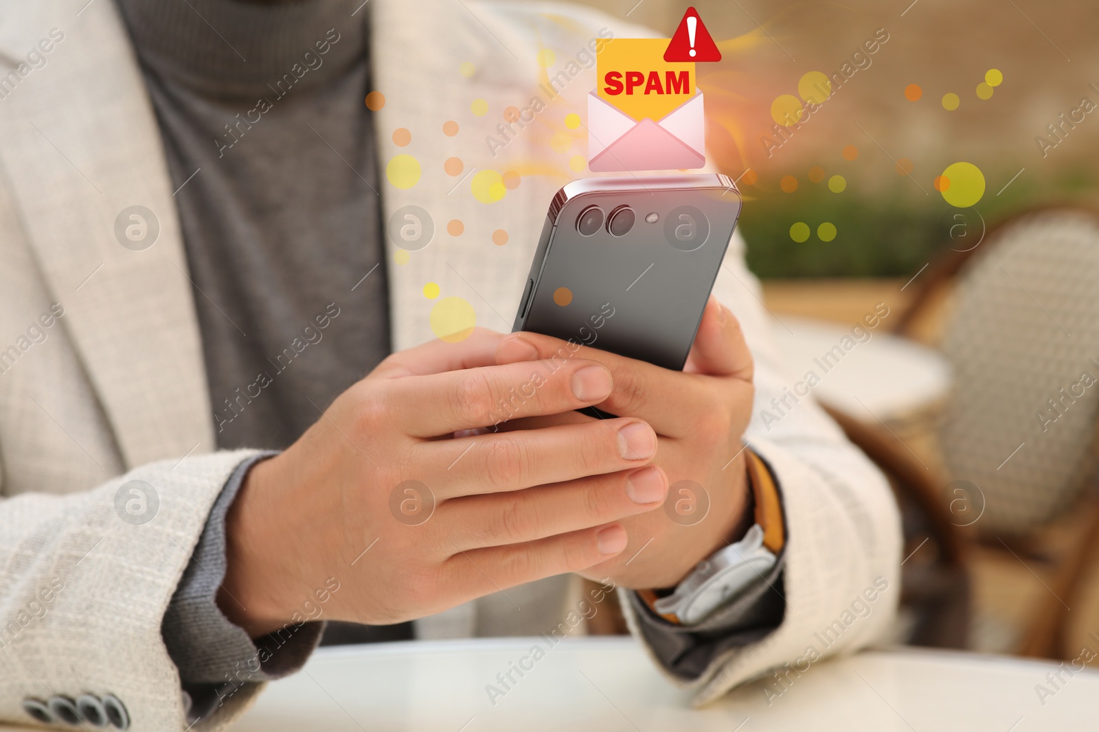Image of Man using smartphone at table indoors, closeup. Spam message notification above device, illustration