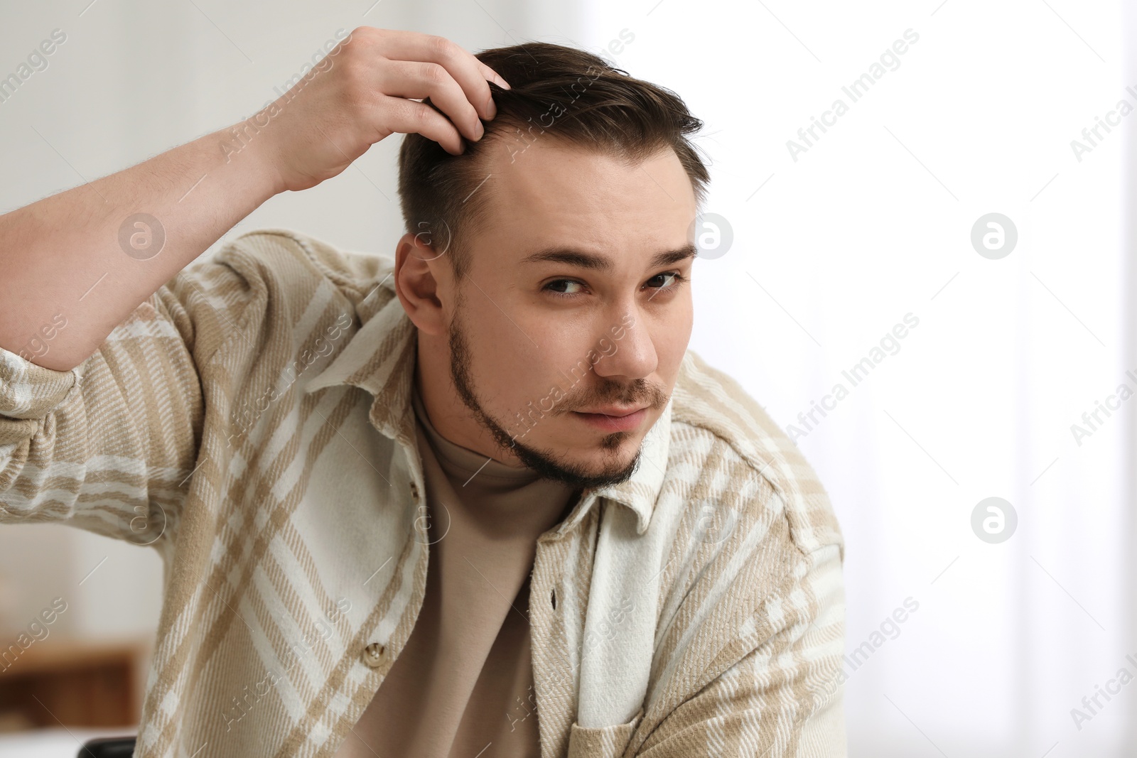 Photo of Baldness concept. Sad man with receding hairline indoors