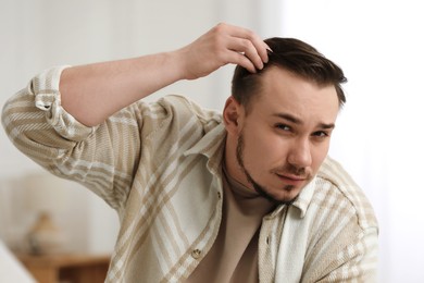 Photo of Baldness concept. Sad man with receding hairline indoors