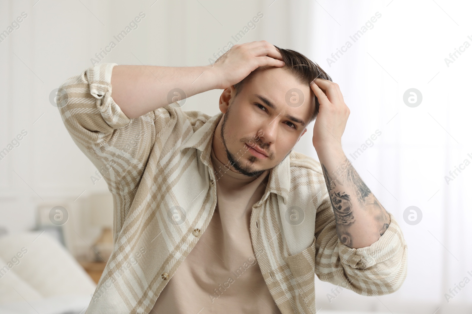 Photo of Baldness concept. Sad man with receding hairline indoors