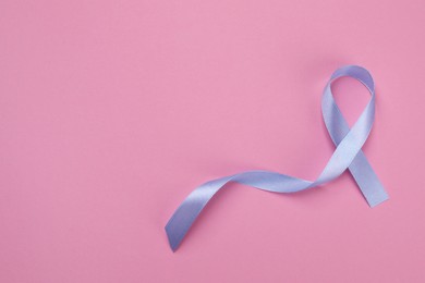 International Psoriasis Day. Ribbon as symbol of support on pink background, top view. Space for text