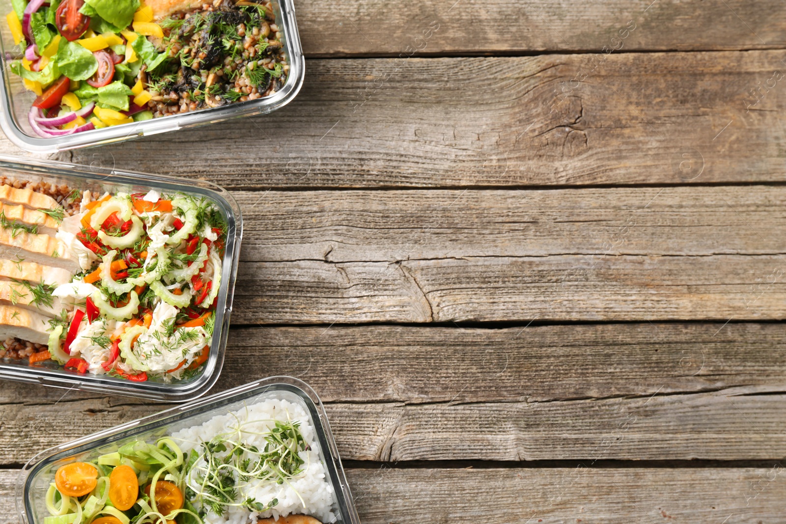 Photo of Healthy meal. Containers with different products on wooden table, flat lay. Space for text