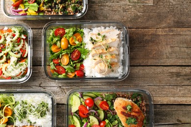 Photo of Healthy meal. Containers with different products on wooden table, flat lay