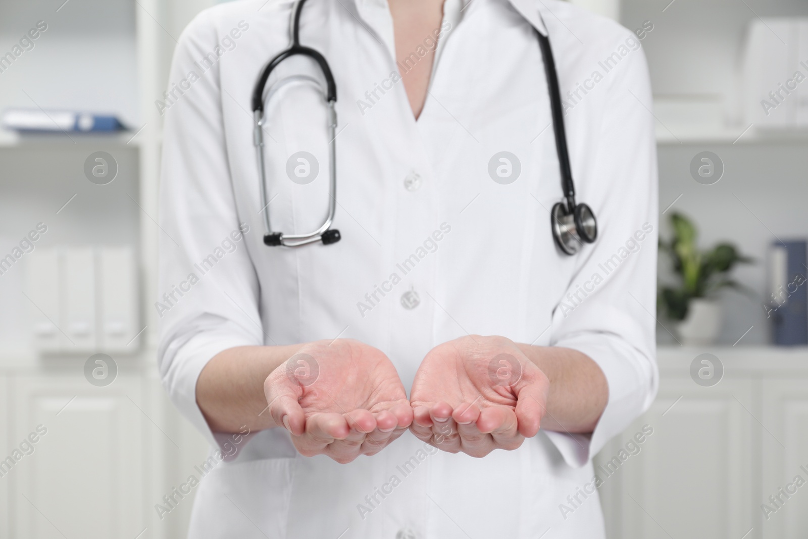 Photo of Doctor holding something in clinic, closeup view