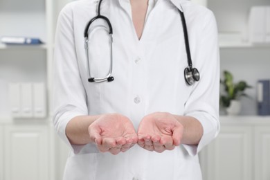 Doctor holding something in clinic, closeup view