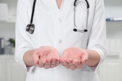 Doctor holding something in clinic, closeup view