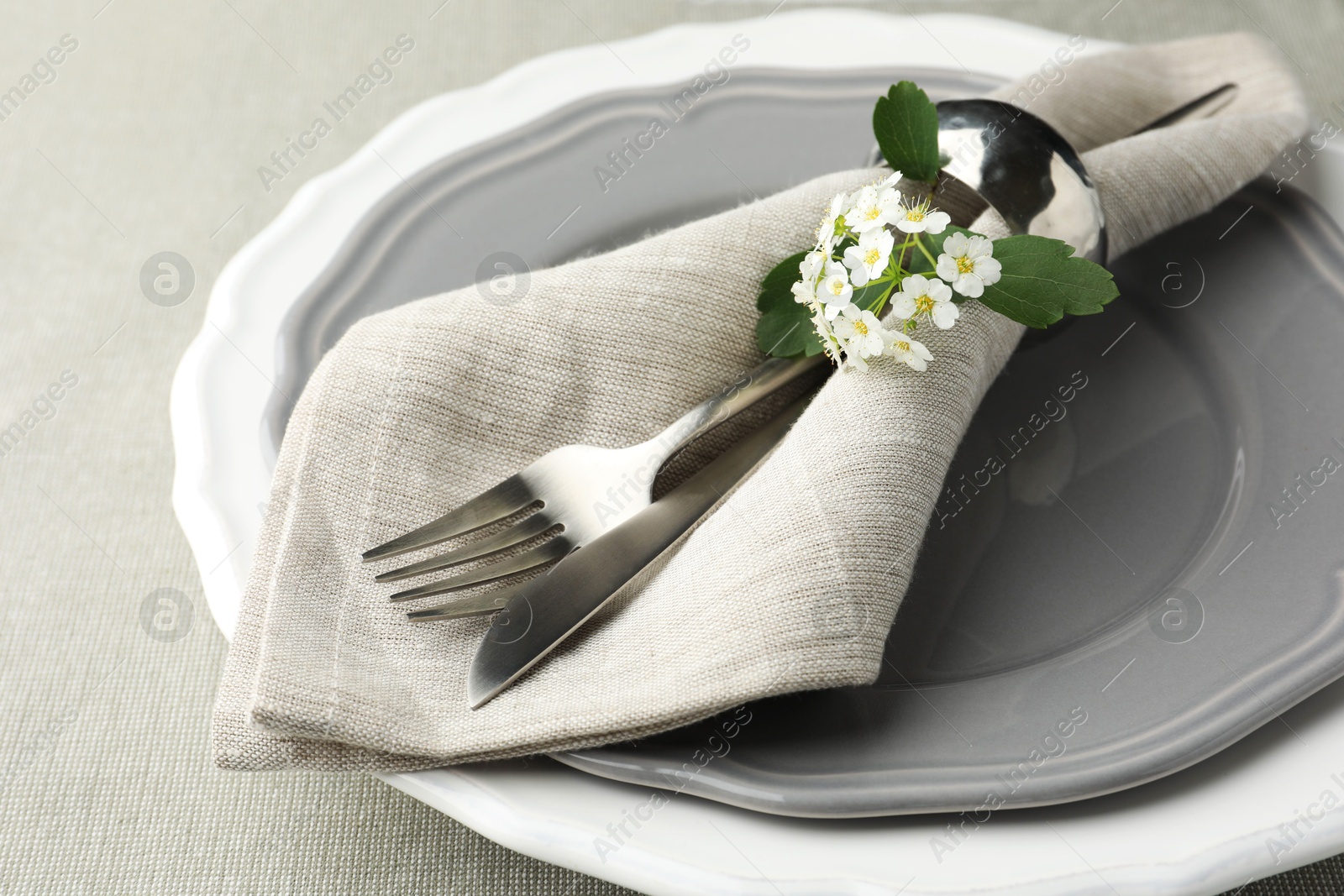 Photo of Stylish setting with cutlery and plates on table, closeup