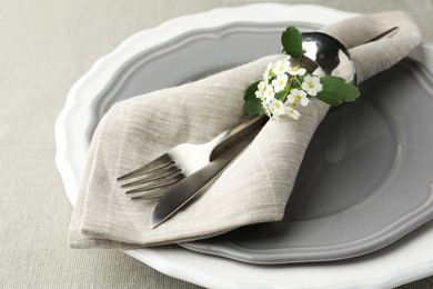 Stylish setting with cutlery and plates on table, closeup