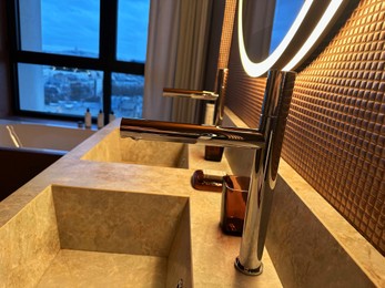 Photo of Modern sinks and faucets in hotel bathroom
