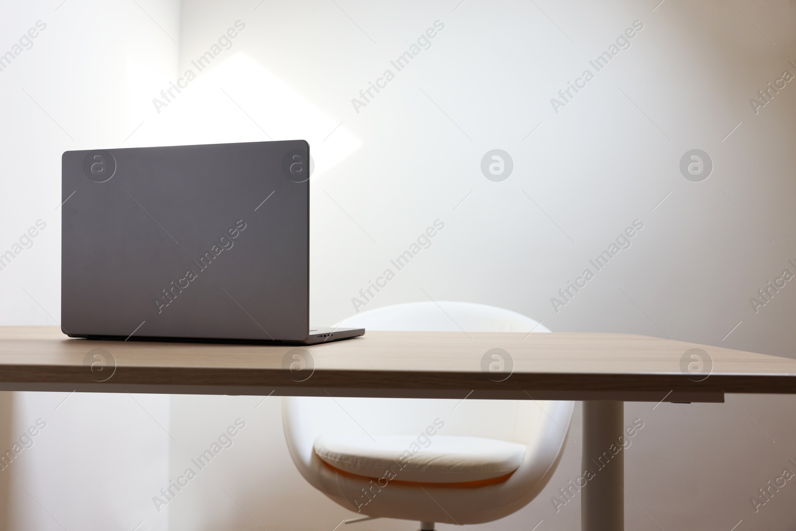 Photo of Stylish modern laptop on wooden table indoors. Space for text