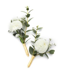 Two small stylish boutonnieres isolated on white, top view