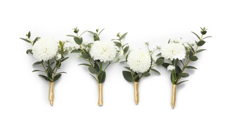 Many small stylish boutonnieres isolated on white, top view
